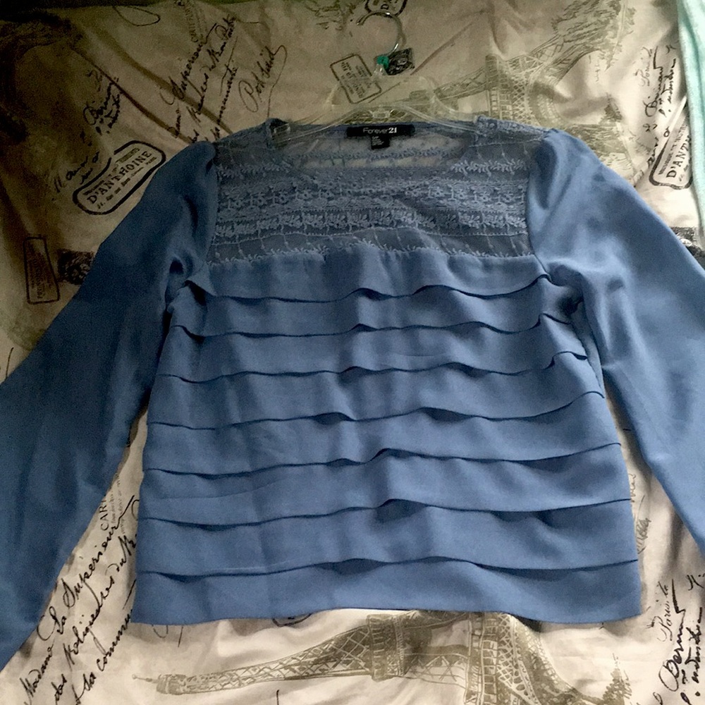 I am selling a blue blouse with cute design on top